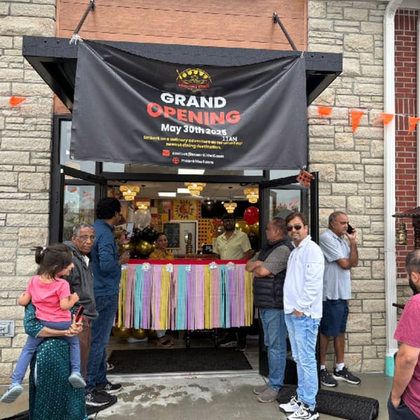 MaanKi Thali & Indian Street Food restaurant grand opening with a banner and people gathered outside.
